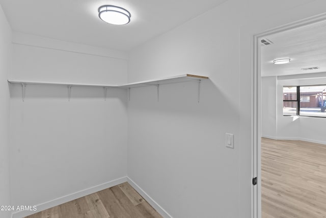 spacious closet featuring visible vents and light wood-type flooring