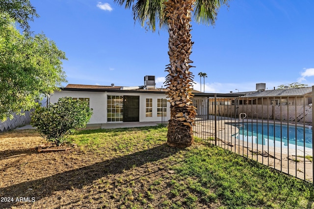 back of property featuring fence, stucco siding, a patio, and a fenced in pool