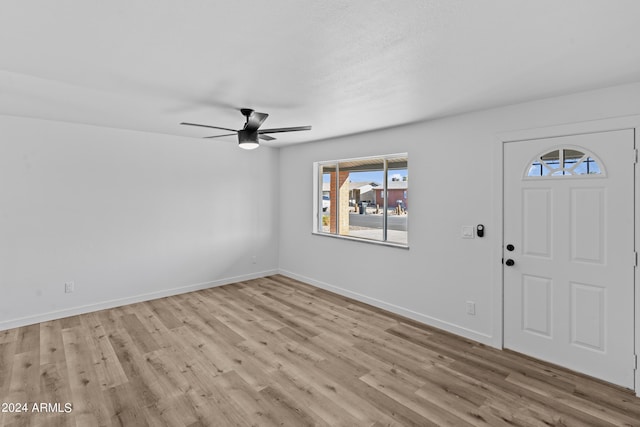 entrance foyer featuring ceiling fan, baseboards, wood finished floors, and a healthy amount of sunlight