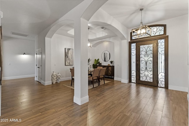 2625 N 24th St Unit 22, Mesa, AZ 85213 - entrance foyer featuring a chandelier, wood finished floors, and arched walkways