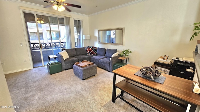 living room with ceiling fan, ornamental molding, and light carpet