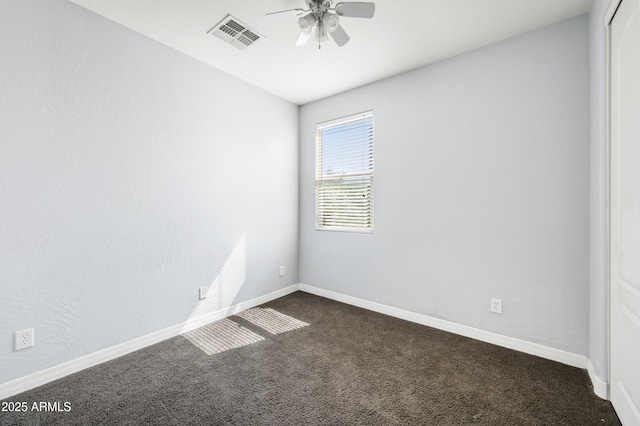 unfurnished room featuring ceiling fan, baseboards, visible vents, and dark colored carpet