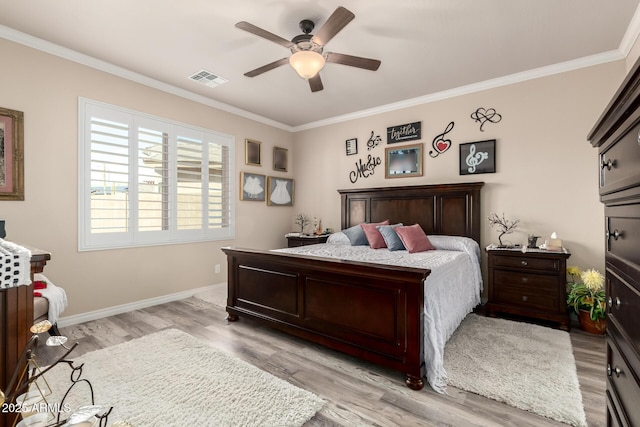 bedroom with ornamental molding, visible vents, and light wood-style floors