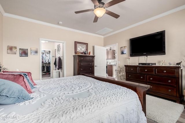 bedroom with ceiling fan, a spacious closet, ornamental molding, and visible vents