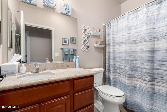 bathroom with curtained shower, vanity, and toilet