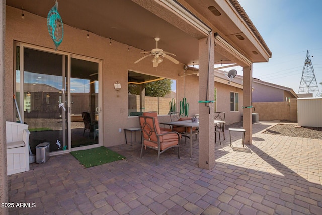 view of patio / terrace featuring ceiling fan, outdoor dining area, and fence