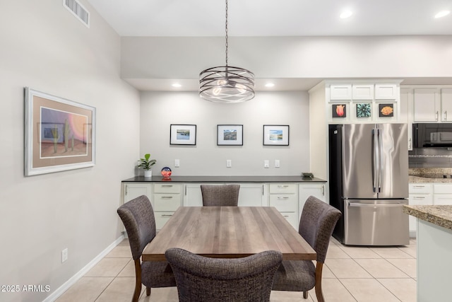 dining space featuring light tile patterned flooring