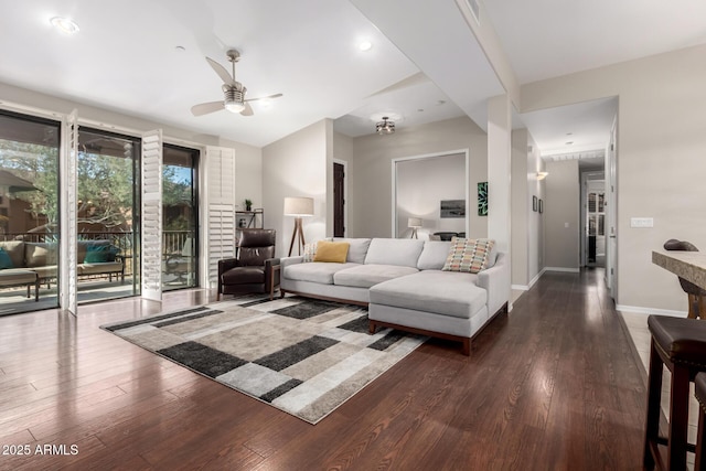 living room with dark wood-type flooring and ceiling fan