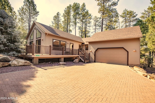 view of front of house featuring a garage and a wooden deck