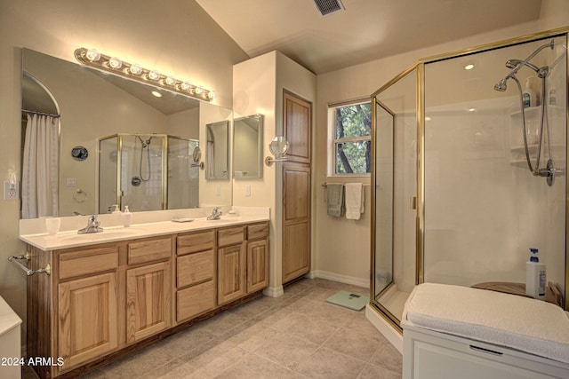 bathroom with tile patterned flooring, vanity, an enclosed shower, and vaulted ceiling