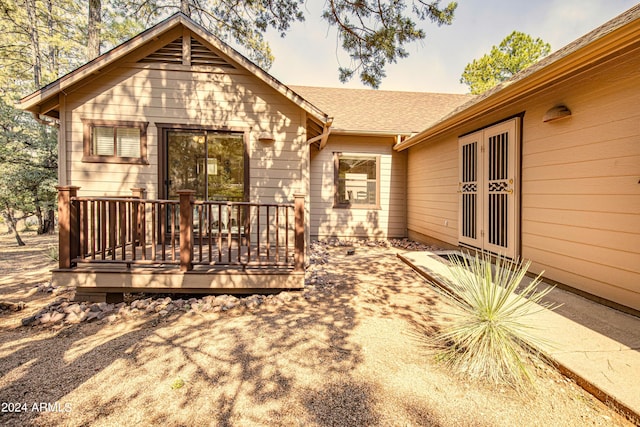 rear view of property with french doors and a deck