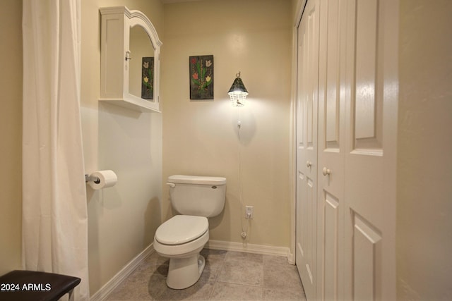 bathroom featuring tile patterned flooring and toilet