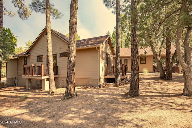 back of house featuring a deck