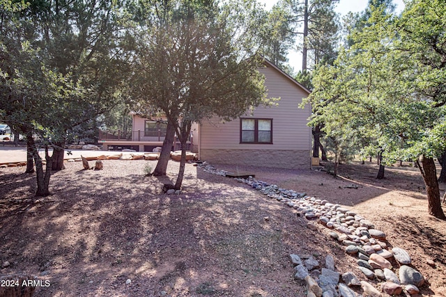 view of side of home featuring a wooden deck