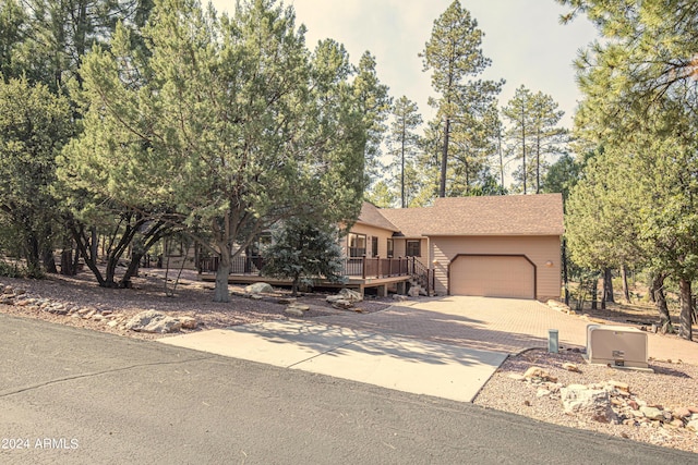 view of front of home with a garage and a wooden deck