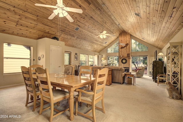 carpeted dining space with ceiling fan, high vaulted ceiling, and wood ceiling