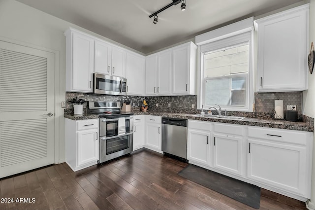 kitchen featuring track lighting, white cabinets, sink, dark hardwood / wood-style flooring, and stainless steel appliances