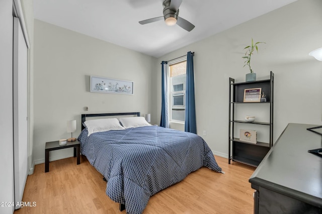 bedroom with ceiling fan, light hardwood / wood-style floors, and a closet