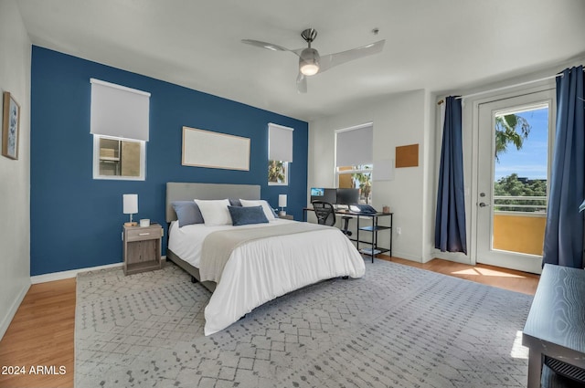 bedroom with access to exterior, ceiling fan, and light hardwood / wood-style flooring