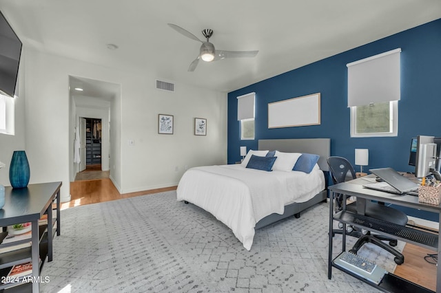 bedroom with light wood-type flooring and ceiling fan