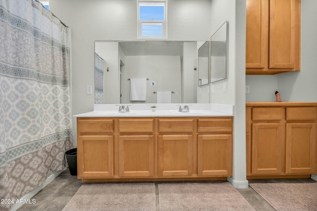 bathroom featuring tile patterned flooring, vanity, and walk in shower