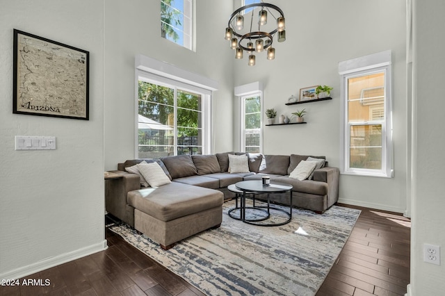 living room with a chandelier and dark wood-type flooring