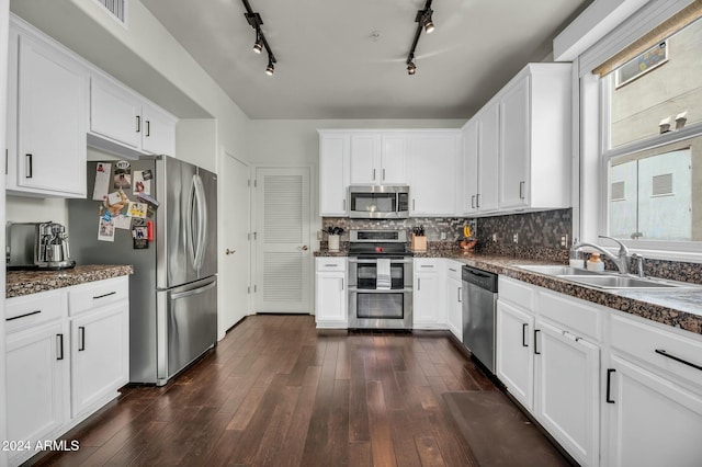 kitchen with dark hardwood / wood-style floors, sink, white cabinetry, and stainless steel appliances