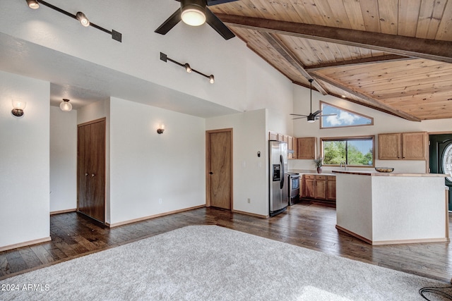 kitchen featuring ceiling fan, beamed ceiling, appliances with stainless steel finishes, and dark hardwood / wood-style flooring