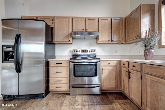 kitchen featuring stainless steel appliances and dark wood-type flooring