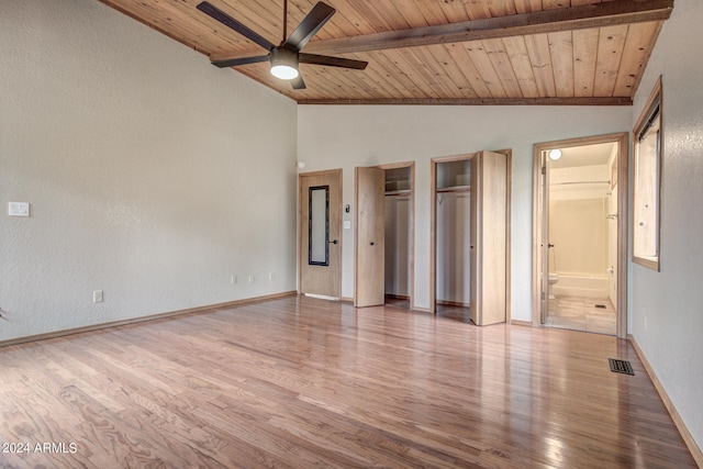 unfurnished bedroom featuring wood ceiling, light wood-type flooring, connected bathroom, vaulted ceiling with beams, and ceiling fan