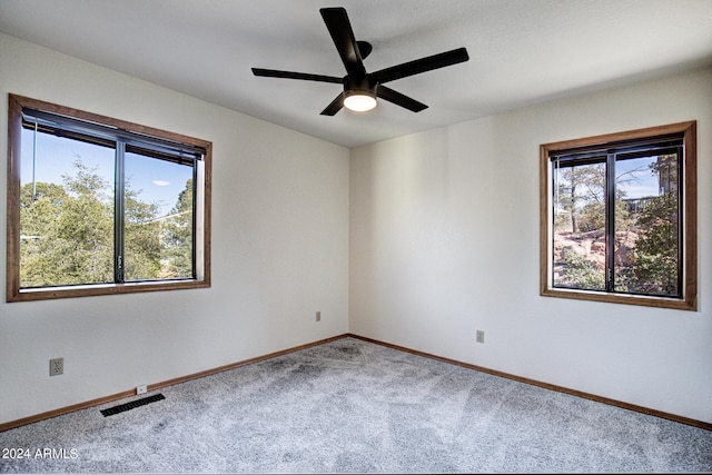 carpeted empty room featuring ceiling fan