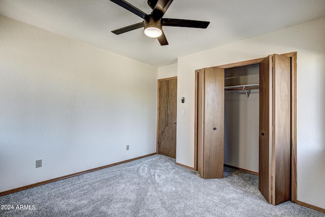 unfurnished bedroom featuring ceiling fan, a closet, and light carpet