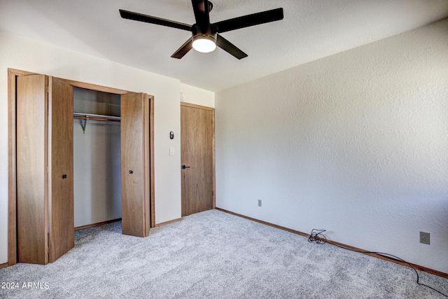 unfurnished bedroom featuring ceiling fan and light colored carpet