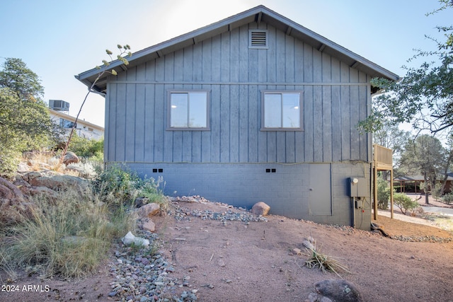 view of side of home with central AC unit