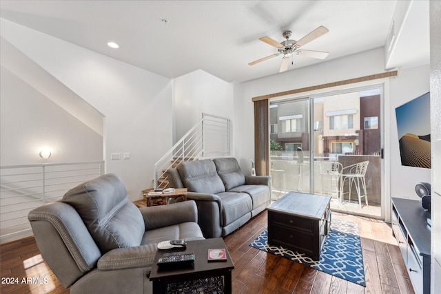 living room featuring ceiling fan and dark hardwood / wood-style floors