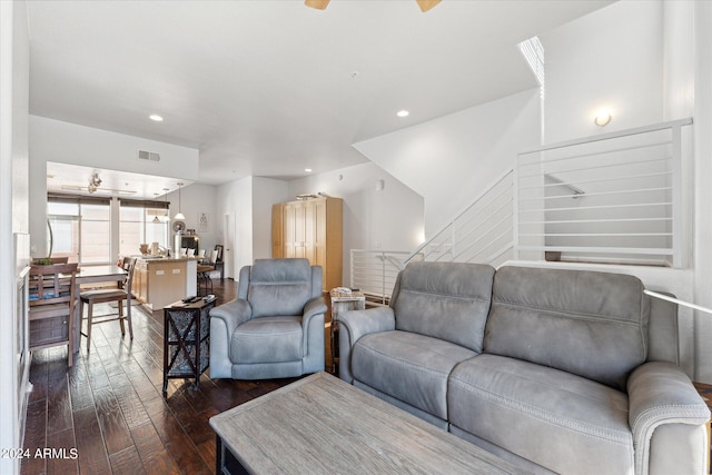 living room with ceiling fan and dark hardwood / wood-style flooring