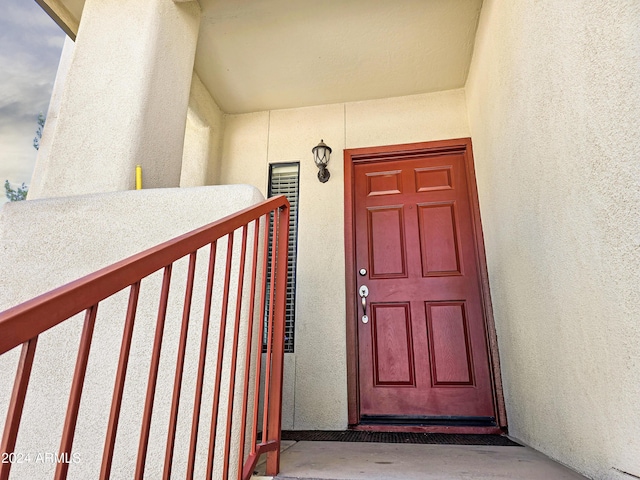 view of exterior entry with stucco siding