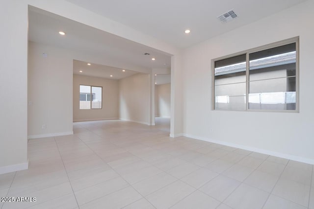 spare room featuring light tile patterned flooring