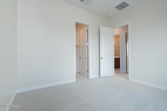 unfurnished bedroom featuring light carpet