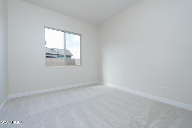 unfurnished room featuring light carpet