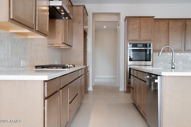 kitchen with light tile patterned floors, appliances with stainless steel finishes, extractor fan, and backsplash