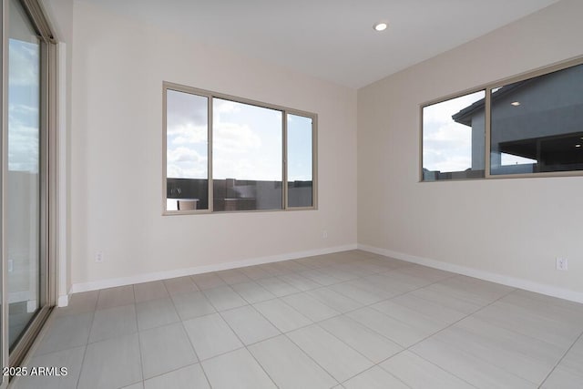 unfurnished room featuring light tile patterned flooring and a healthy amount of sunlight