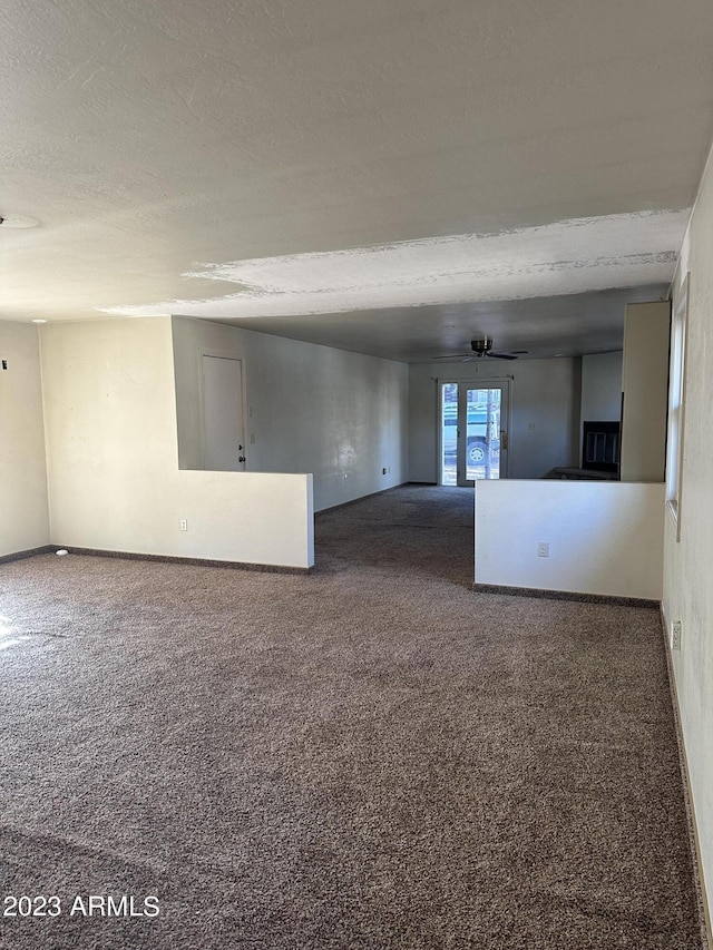 interior space with ceiling fan and a textured ceiling