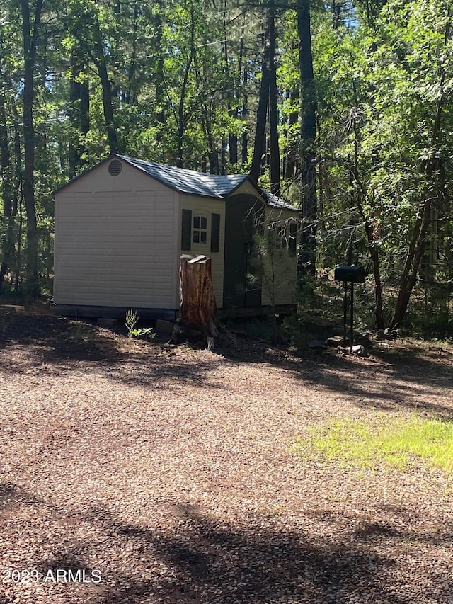 exterior space with a shed