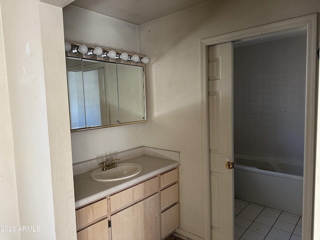 bathroom with tiled shower / bath, tile floors, and vanity