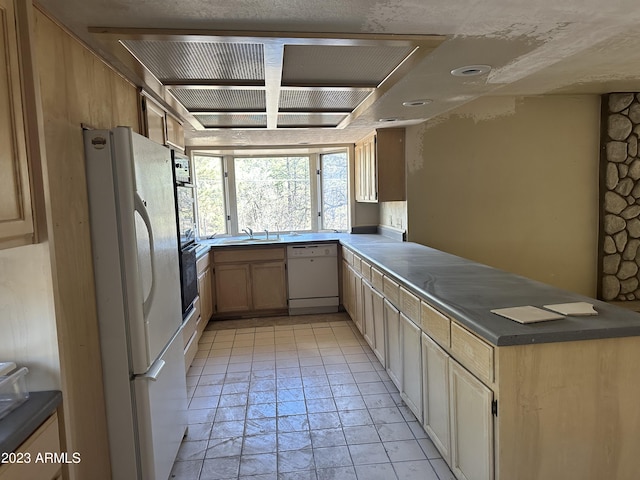 kitchen with white appliances, sink, and light tile floors