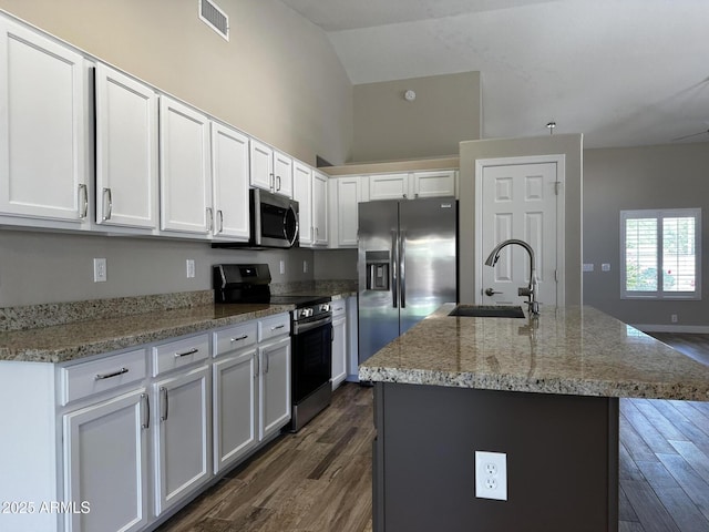 351 N Newport St, Chandler, AZ 85225 - kitchen featuring appliances with stainless steel finishes, dark wood finished floors, white cabinetry, light stone countertops, and high vaulted ceiling