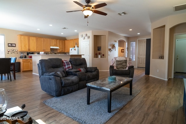 living room featuring light wood-type flooring and ceiling fan