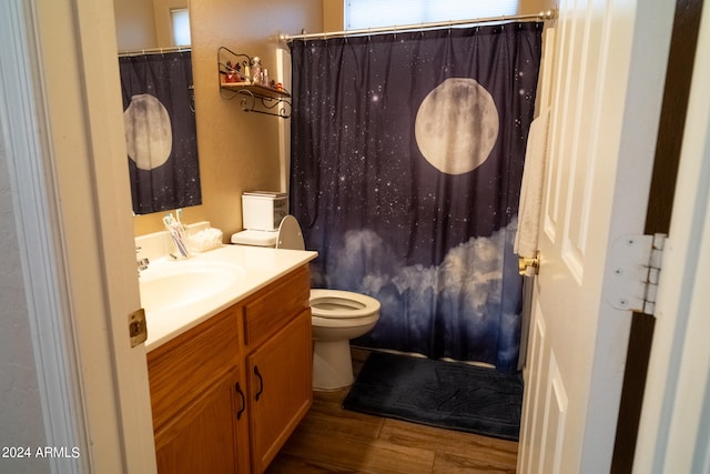 bathroom with curtained shower, toilet, vanity, and hardwood / wood-style flooring