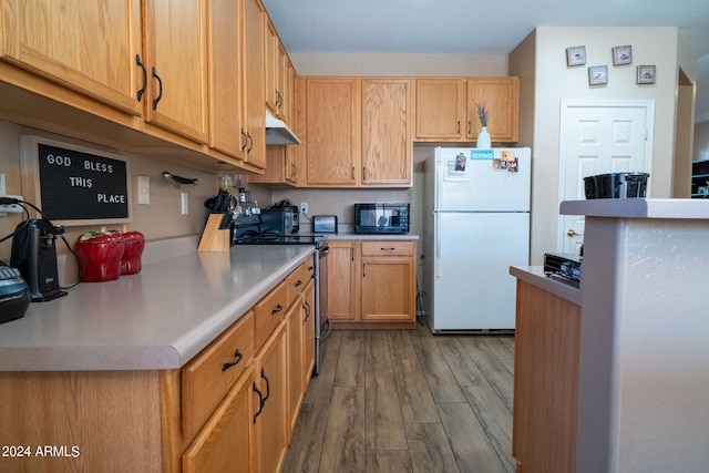 kitchen featuring hardwood / wood-style floors, white fridge, and stainless steel range with electric stovetop